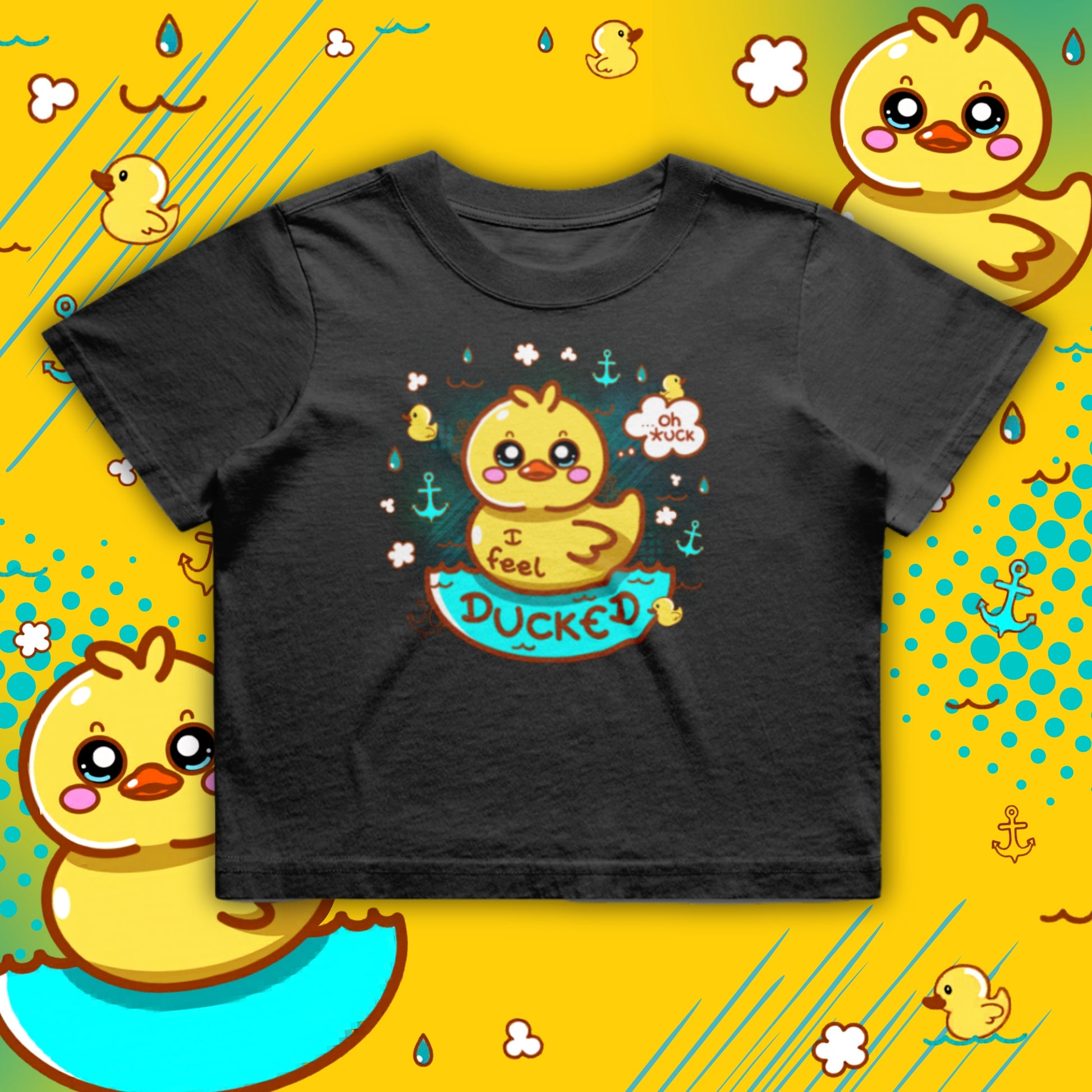 Black cropped T-shirt featuring a cute yellow duck illustration with the phrase “I Feel Ducked”. The duck sits in blue water surrounded by small ducks, raindrops and anchors. Playful, colourful graphic on a boxy, oversized crop tee by Innabox, a disability positive brand supporting chronic illness and hidden disabilities.