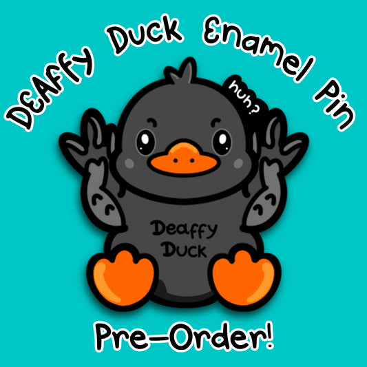 Deaffy Duck enamel pin by Innabox, featuring a cute black duck with orange beak and feet, holding their wings up in British Sign Language. Text reads Deaffy Duck Enamel Pin Pre Order on a teal background. Disability inspired pin celebrating deaf identity, BSL and hidden disabilities in a gentle, uplifting way.
