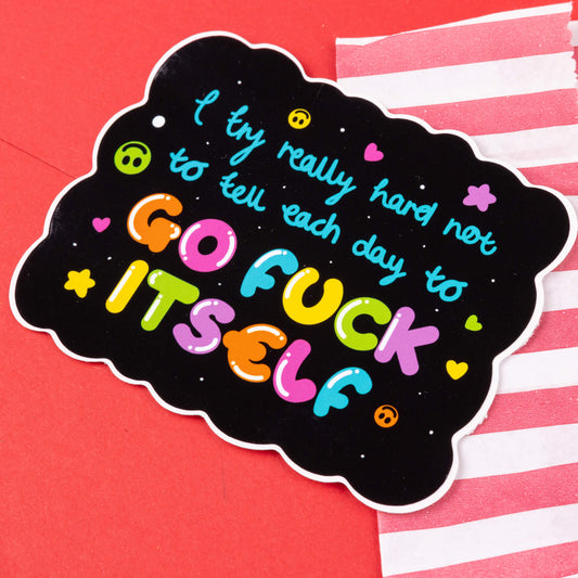 A sticker with a black background and wavy edges, displaying the text "I try really hard not to tell each day to GO FUCK ITSELF" in colorful letters. The text is accented by small heart, star, and smiley face icons. The sticker is set against a red background with a diagonal white and red striped pattern. Hand drawn design created to raise awareness for chronic and invisible illnesses.