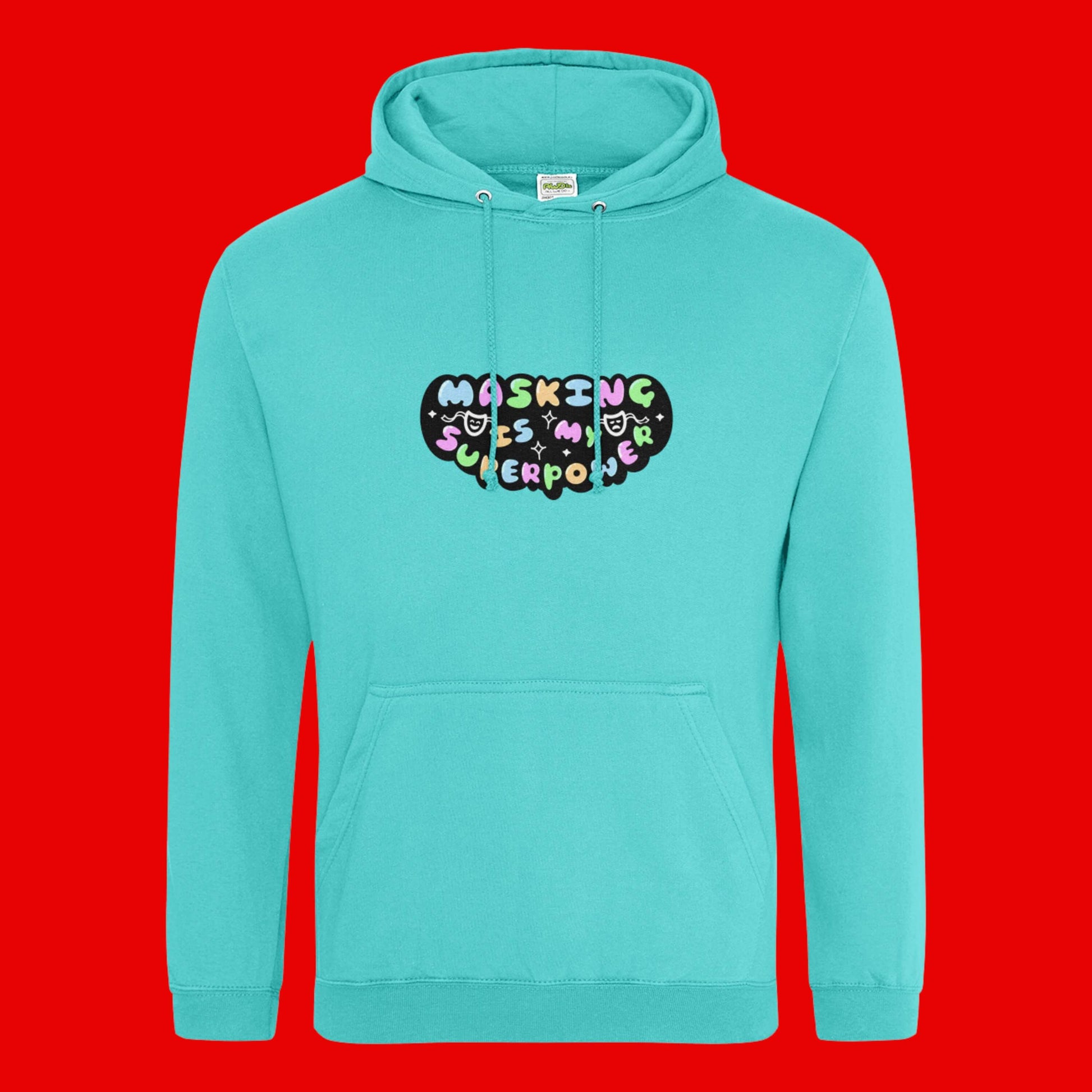 The turquoise surf Masking Is My Super Power Hoodie on a red background. The aqua blue hoodie features pastel rainbow bubble writing that reads 'masking is my superpower' with white sparkles, a happy and sad drama masks all on a black oval. Raising awareness for neurodivergent people with ADHD or Autism.