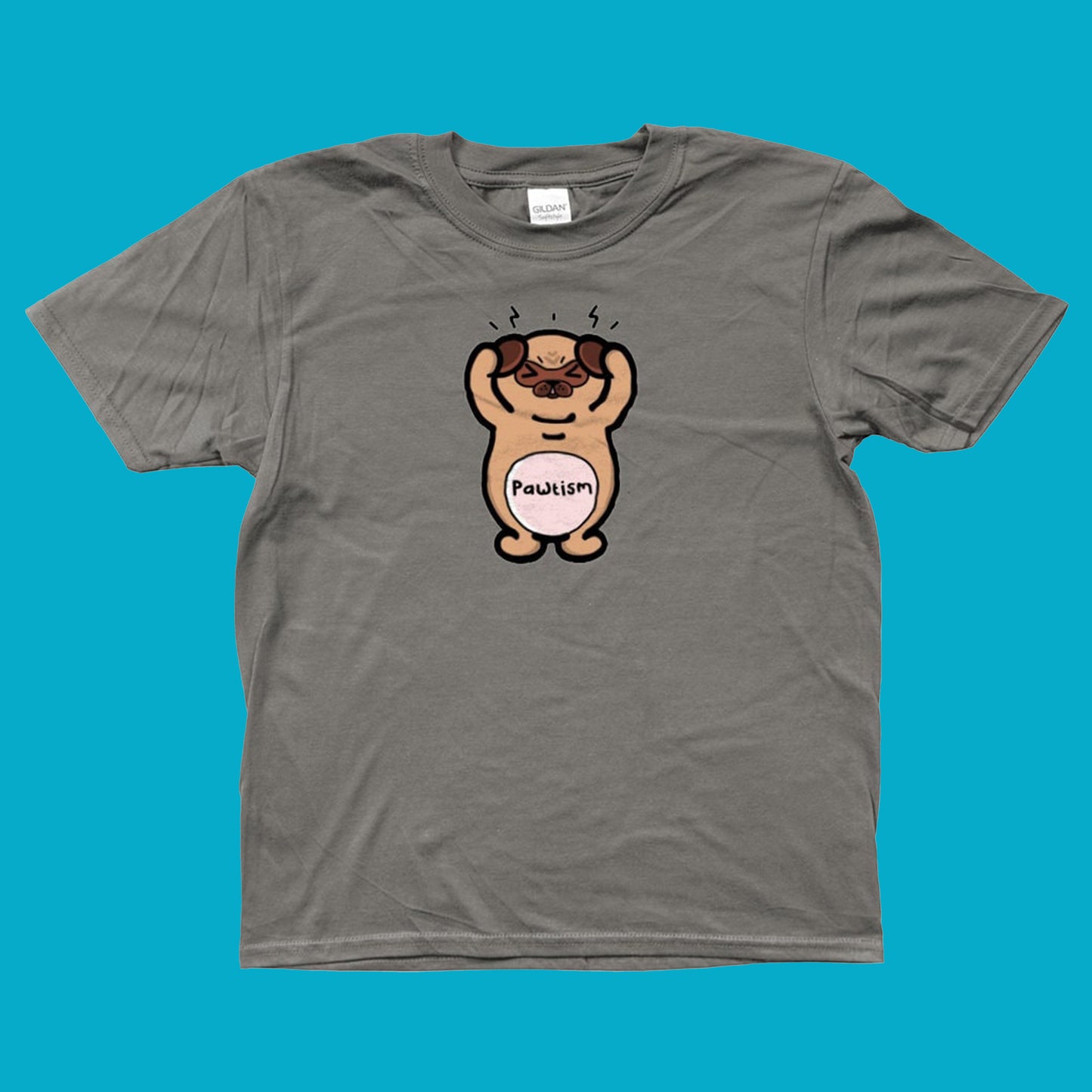 The Pawtism Dog Kids Tee - Autism on a blue background. The charcoal grey short sleeve tshirt features a stressed pug dog covering its ears with black lines coming from the top of its head, across its body in black text reads 'pawtism'. The hand drawn design is raising awareness for autism and neurodivergence.