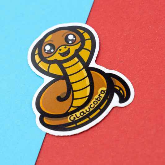 Glaucobra pun sticker by Innabox featuring a cute cartoon cobra snake with big sparkly eyes, designed to raise awareness for glaucoma.