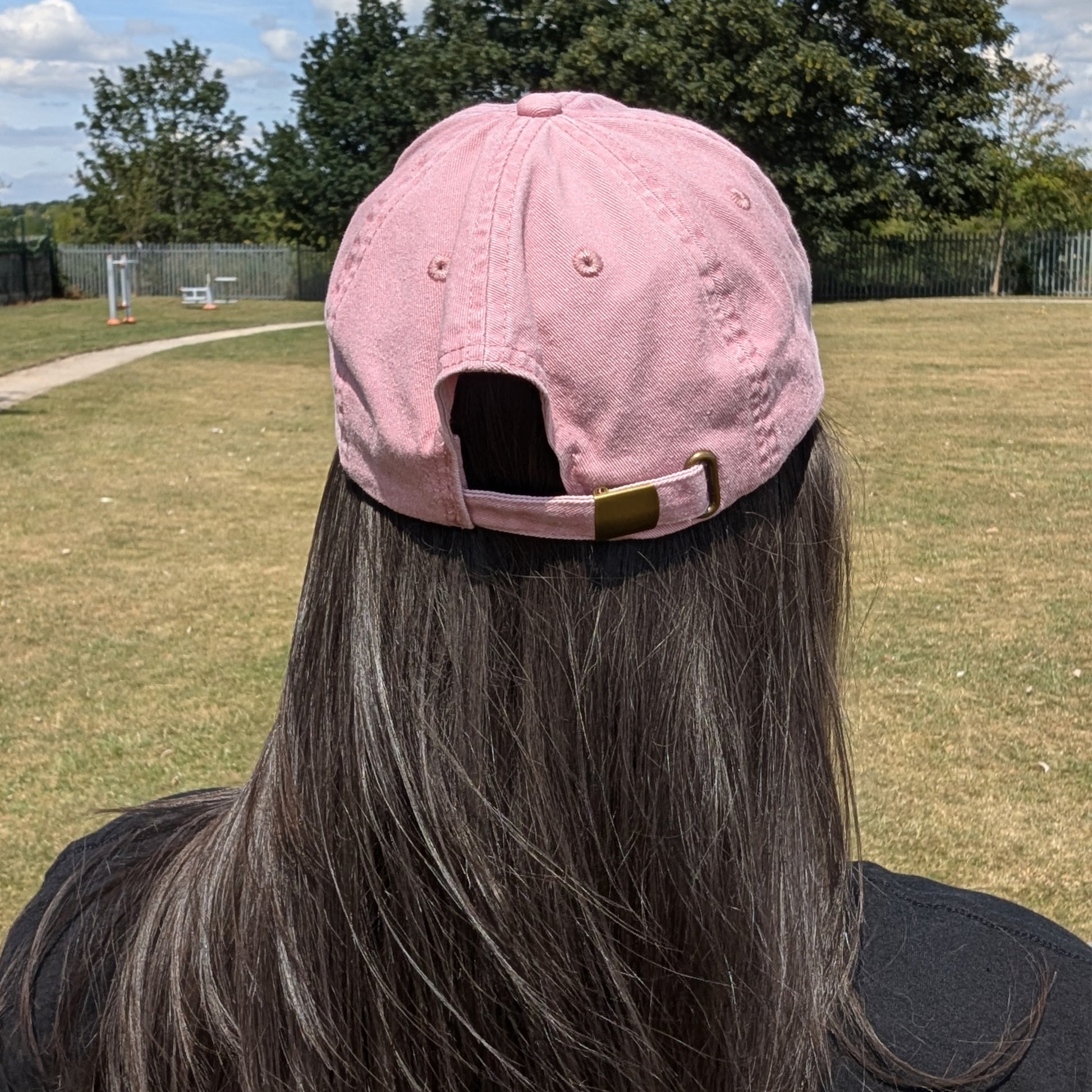 Back view of a person wearing the Hot and Neuro-Spicy cap by Innabox, showing the adjustable brass-effect buckle and soft vintage-style cotton finish.