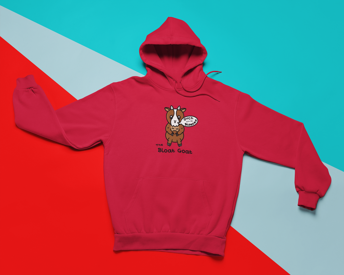 A red hoodie with a little brown goat with little white horns and a white centre of it's face. The goat has big sparkly eyes with angular eyebrows and moth in an 'o' shape with a white speech bubble coming out of it with 'ouch I'm so Bloated" written inside it. The goat is holding onto it's light brown fluffy tummy with it's upper legs. 'The Bloat Goat' is written in black under the goat.