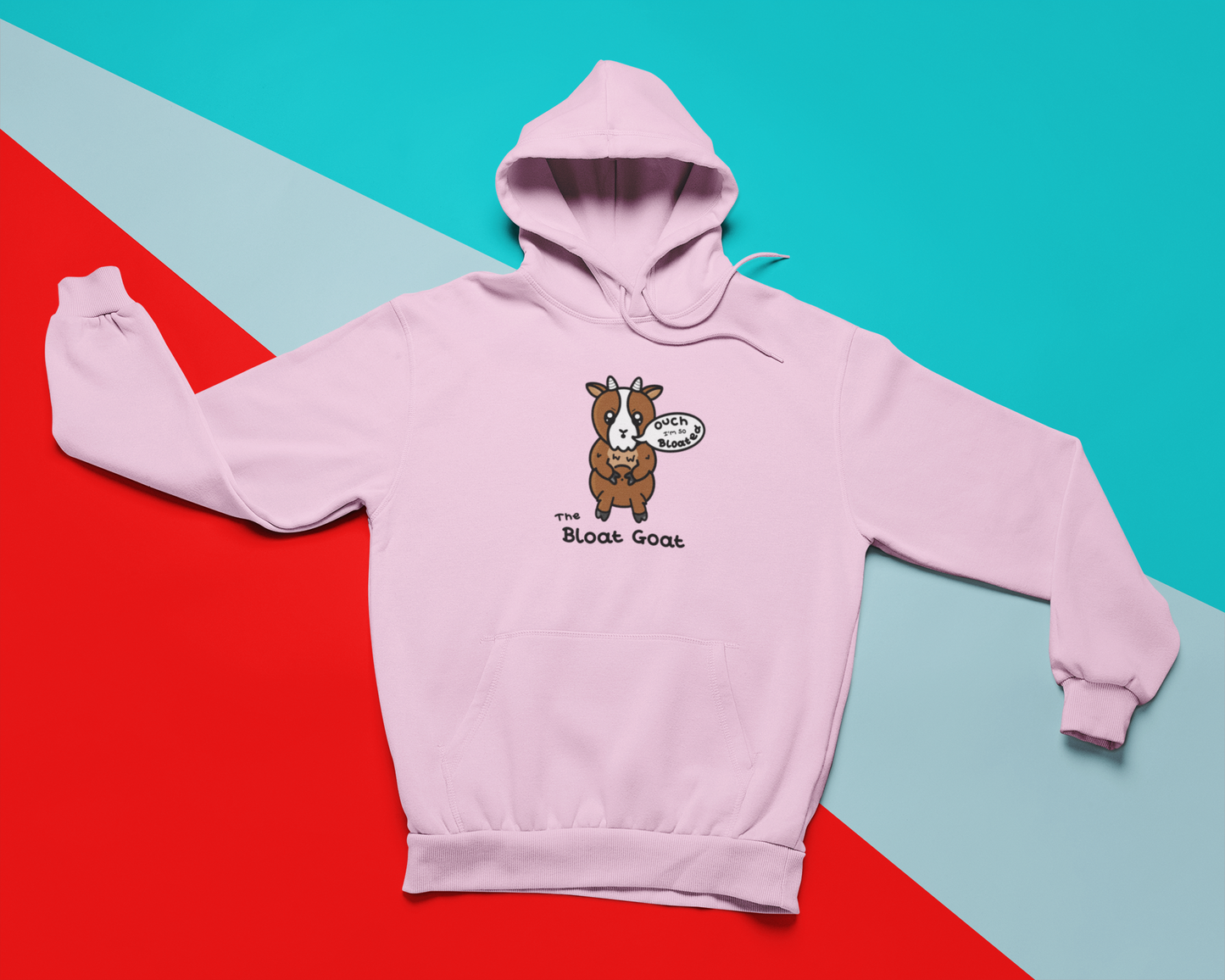 A pink hoodie with a little brown goat with little white horns and a white centre of it's face. The goat has big sparkly eyes with angular eyebrows and moth in an 'o' shape with a white speech bubble coming out of it with 'ouch I'm so Bloated" written inside it. The goat is holding onto it's light brown fluffy tummy with it's upper legs. 'The Bloat Goat' is written in black under the goat.