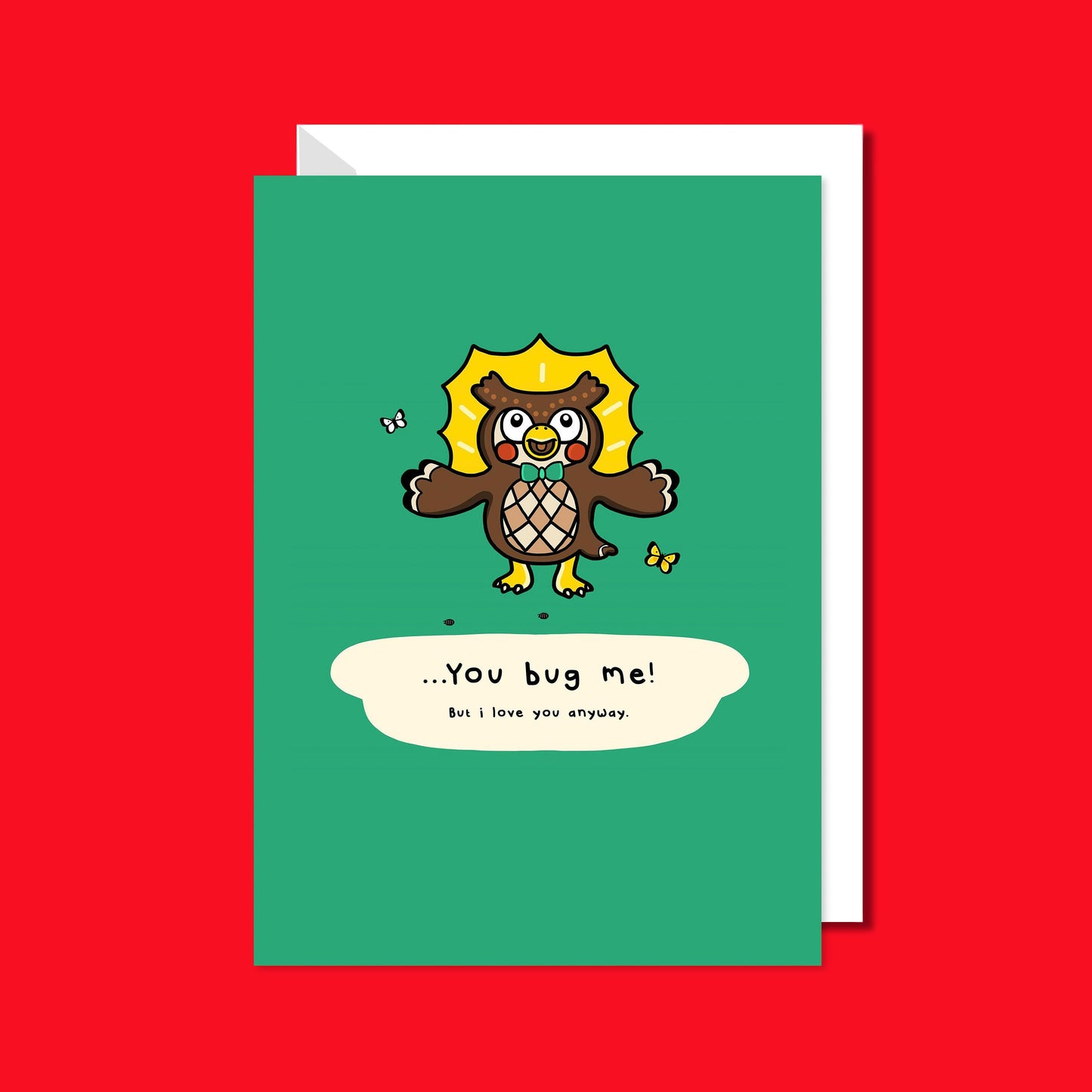The You Bug Me! But I Love You Anyway Card on a red background with a white envelope underneath. The green a6 sassy card features blathers the museum owl from animal crossing looking shocked with a speech bubble underneath reading '... you bug me! but I love you anyway.'