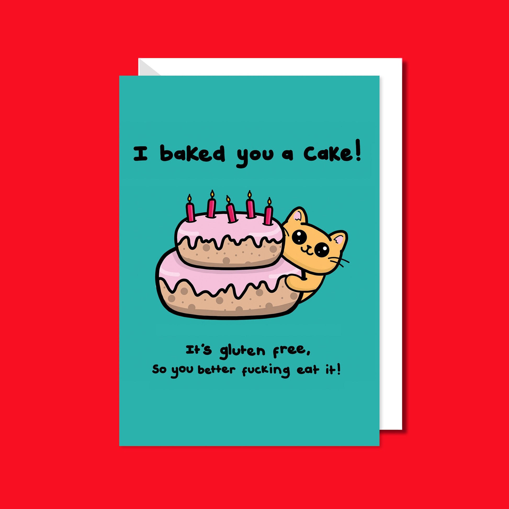 A turquoise blue card that has a drawing of a yellow cat poking around a pink layered cake with candles in the top. Text on the card says I baked you a cake! It's gluten free, so you better fucking eat it! The a6 cat themed birthday card is on a red background with a white envelope underneath.