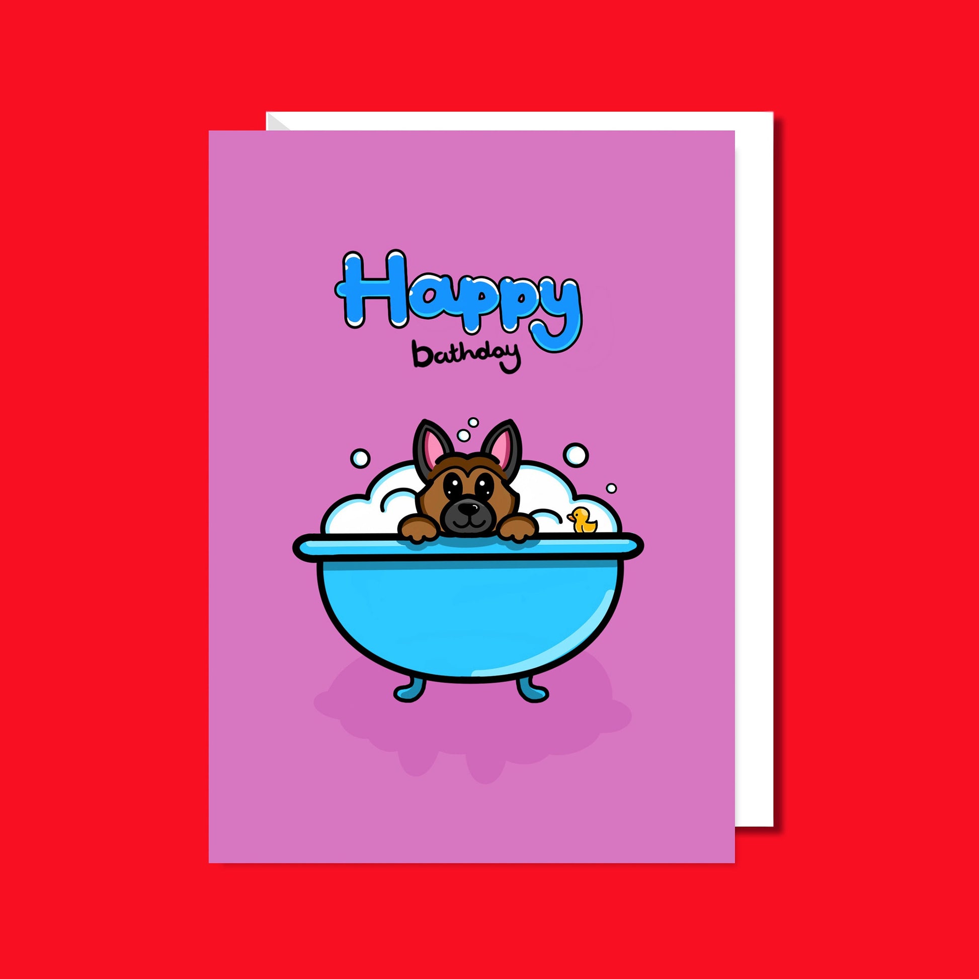 The Happy Bathday Dog Birthday Card on a red background with a white envelope underneath. The pink base a6 card features a happy alsatian german shepherd dog peeking over a blue bath tub full of bubbles and a yellow rubber duck. Above this reads 'happy bathday' in blue bubble writing for 'happy' and black script writing for 'bathday'. The birthday themed card is inspired by dog parents, dog lovers and celebrations.