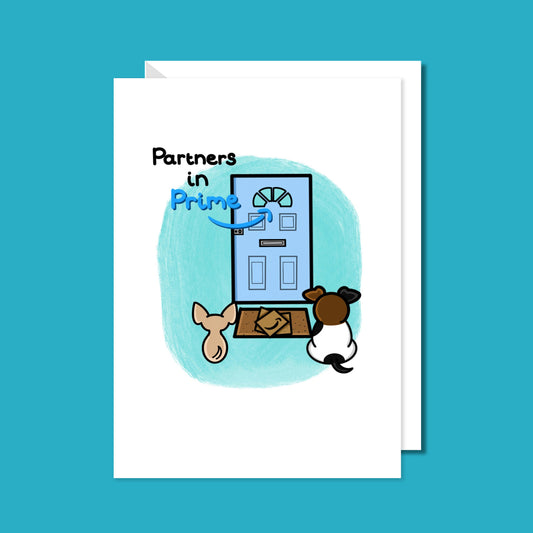 The Partners In Prime Pet Card on a blue background with a white envelope underneath. A card with an illustration of two dogs waiting by a front door with parcels on a doormat with partners in prime written on it. 